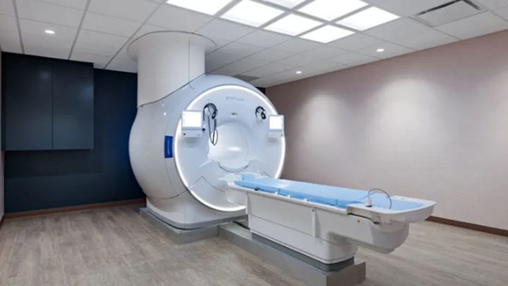 MRI scanner with a circular bore and patient table in a modern radiology room